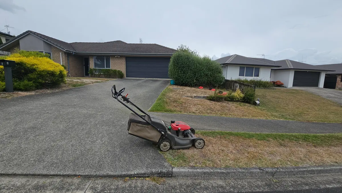 House exterior with a mowed front lawn and driveway